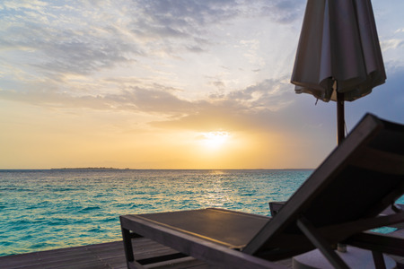 Beautiful tropical Maldives island summer vacation relaxing at overwater villa in luxury resport.の写真素材