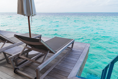 Beautiful tropical Maldives island summer vacation relaxing at overwater villa in luxury resport.の写真素材