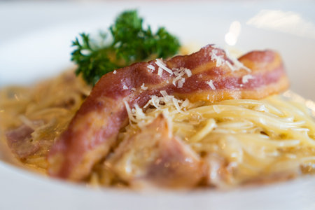 Close up. Delicious fresh spaghetti carbonara with bacon smoked dipping, on white dish, in luxury restaurant, italian pizza food concept.の写真素材