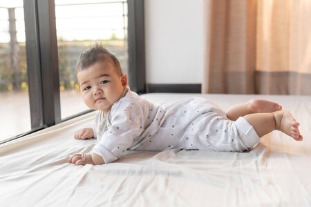 Asian cute baby boy happiness on nature outside window background.の写真素材