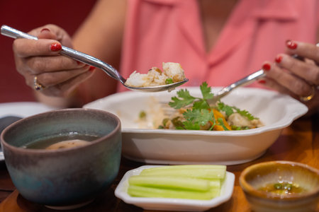 Fried rice with crab meat on spoon. eating on wood table in luxury restaurant. Thai food. Asia food style.の写真素材