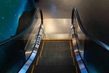 Modern luxury escalators with staircase Escalator in Community Mall, Shopping Center. Moving up staircase. electric escalator. Close up to escalators.の写真素材