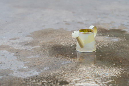 Small yellow watering bucket in vintage style.