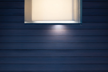 Modern square style decoration lamp and lampshades against dark blue wood wall.