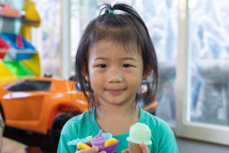 Portrait of small girl. Asian cute little girl play icecream toy stay at home.の写真素材