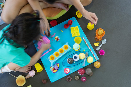 Asian young mom stay at home play with plasticine modeling clay with little daughter, happy mother...