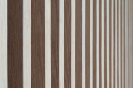 Close up. Seamless pattern of modern wall covering with light brown wooden slats. Background interior design.の写真素材