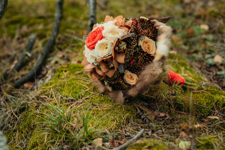 Wedding bouquet with fur that lies on the mossの写真素材