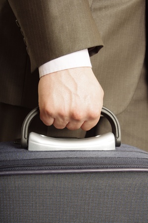 man holding luggageの写真素材