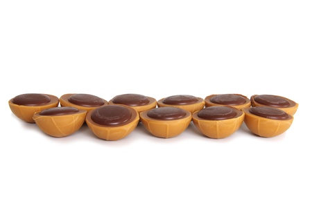 toffee chocolates arranged in two lines on white backgroundの写真素材
