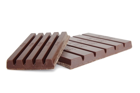 blocks of dark chocolate with grams on white backgroundの写真素材