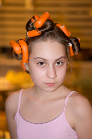 the girl clocked curlers and posingの写真素材