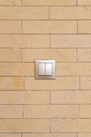electrical swich on yellow textured wall
