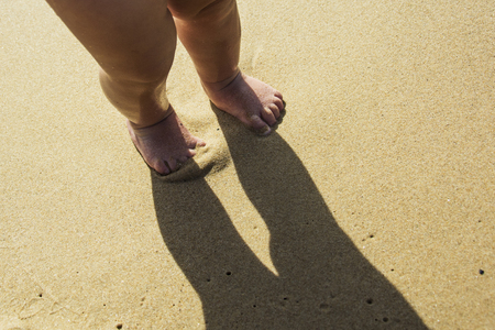 The feet that trample the sandの写真素材