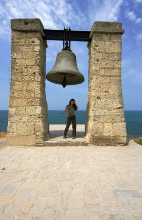 Portrait of the beautiful girl on a background of ancient greek ruinsの写真素材