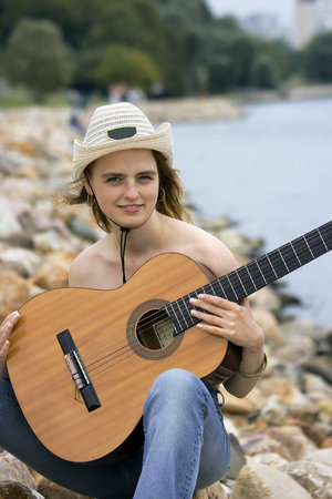 Portrait of the girl with a guitar topless