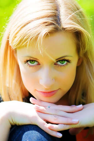 Portrait of the beautiful girl in spring parkの写真素材