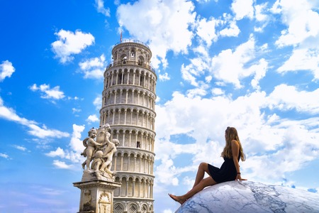 young girl admiring the Leaning Tower in Italy, on a sunny dayの写真素材