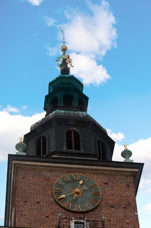 The clock on the town hall tower on main square in Krakow close-up, Poland.の写真素材