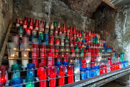 MONTSERRAT, CATALONIA, SPAIN September 2017: Multicolored jaundiced candles in Santa Maria de Montserrat, Spainのeditorial素材