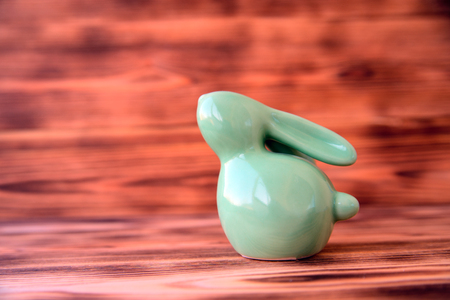 Easter ceramic rabbit on wooden background oneの写真素材