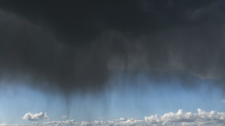 Rainy, dark storm clouds over the sea.の写真素材