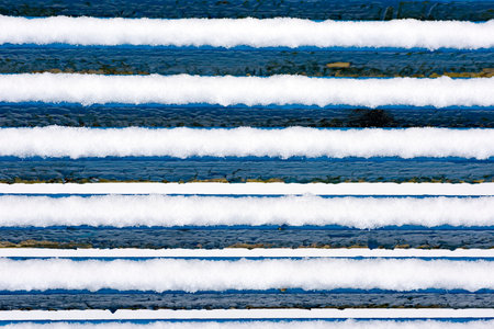 abstract lines of winter snow covered bench.の写真素材