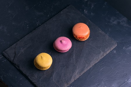 Photo in a dark key French sweet multi-colored macaroonの写真素材