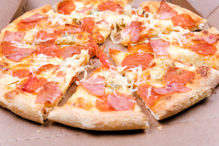 pizza pepperoni close-up on the table with tomatoesの写真素材