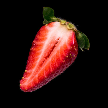 cut strawberry isolated on black backgroundの写真素材