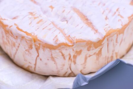 Camembert cheese close-up wrapped in foilの写真素材
