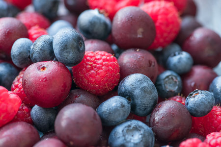 Background of ripe fresh berries raspberry blueberry cherry