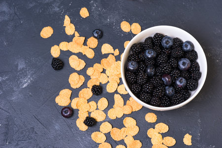 bowl of blackberries, blueberries and cereal. morning natural breakfast