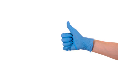 doctors hand in a blue medical glove shows the OK sign, isolated