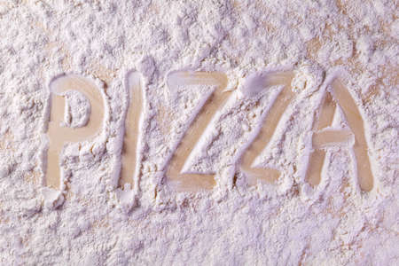 inscription on the kitchen board on the flour pizzaの写真素材