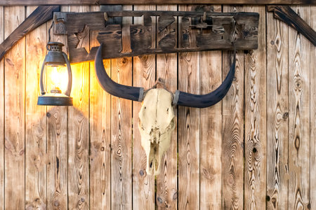 signboard with bull skull and kerosene lamp.の写真素材