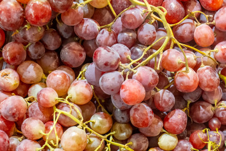 Bunch of red grapes on a supermarket shelf. background. close-up.