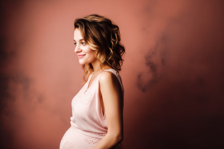 Beautiful pregnant woman in a pink dress on a pink background. Generative AI.の素材