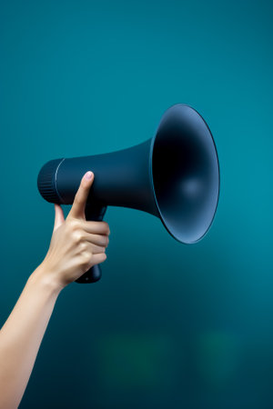 Woman holding a megaphone on a blue background with copy space. Generative AI.の素材