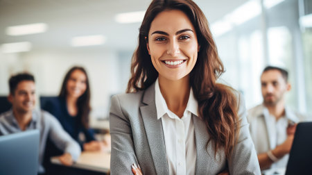 Portrait of beautiful business woman looking at camera and smiling while working in office.の素材