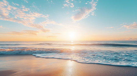 The sun gradually rises above the horizon, casting a warm golden glow over the tranquil ocean waves gently lapping the sandy beach. Early morning light enhances the serene atmosphere.の素材