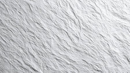A close-up view of a textured white paper surface, revealing soft wrinkles and lines. Natural light creates gentle shadows, enhancing the paper's intricate details.の素材