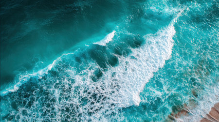 Clear blue waters crash against the sandy shore, creating white foam under a bright sky. This scene captures the beauty of a tropical beach on a sunny day, perfect for relaxation.の素材