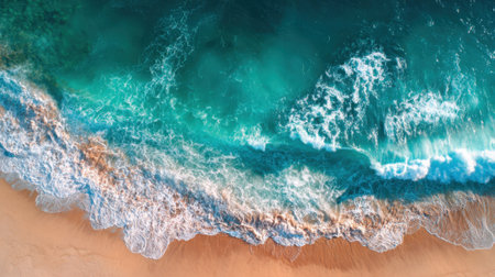 Crystal-clear water meets soft sand at a serene beach. Sunlight sparkles on the surface as waves wash ashore, creating a peaceful atmosphere for relaxation and enjoyment.の素材