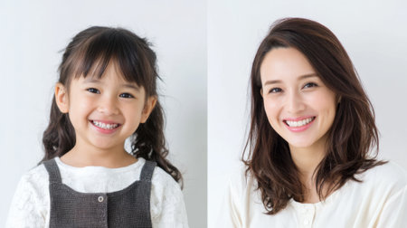 A young girl and her mother both display happy smiles. They are in a bright space with soft lighting, showing their joy and connection as they pose together.の素材
