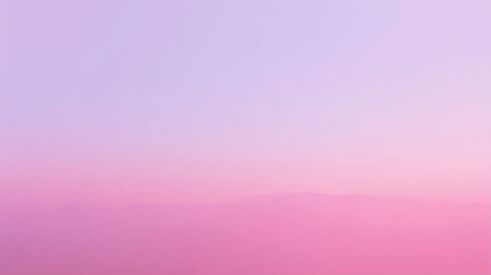 Soft pastel colors blend in the sky as the sun sets behind distant hills creating a calming view.の素材