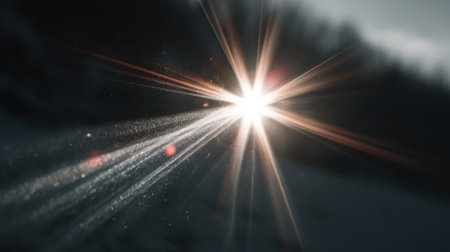 Bright rays of sunlight shine through a snowy scene casting a captivating glow in the winter air.の素材