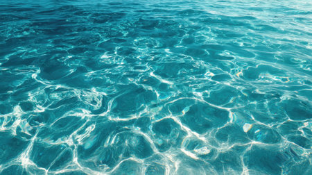 Sunlight dances on the surface of clear turquoise waters creating a serene scene of tranquility.の素材