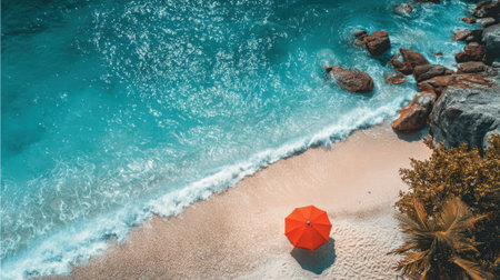 A vibrant orange umbrella stands alone on a sandy beach next to calm turquoise water. Nearby rocks and palm trees add to the serene ambiance of this coastal scene.の素材