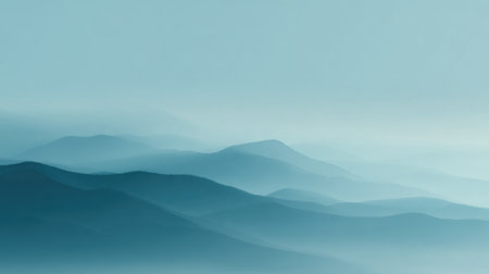 Soft blue mountains rise gently in the distance enveloped in a calming mist at dawn.の素材